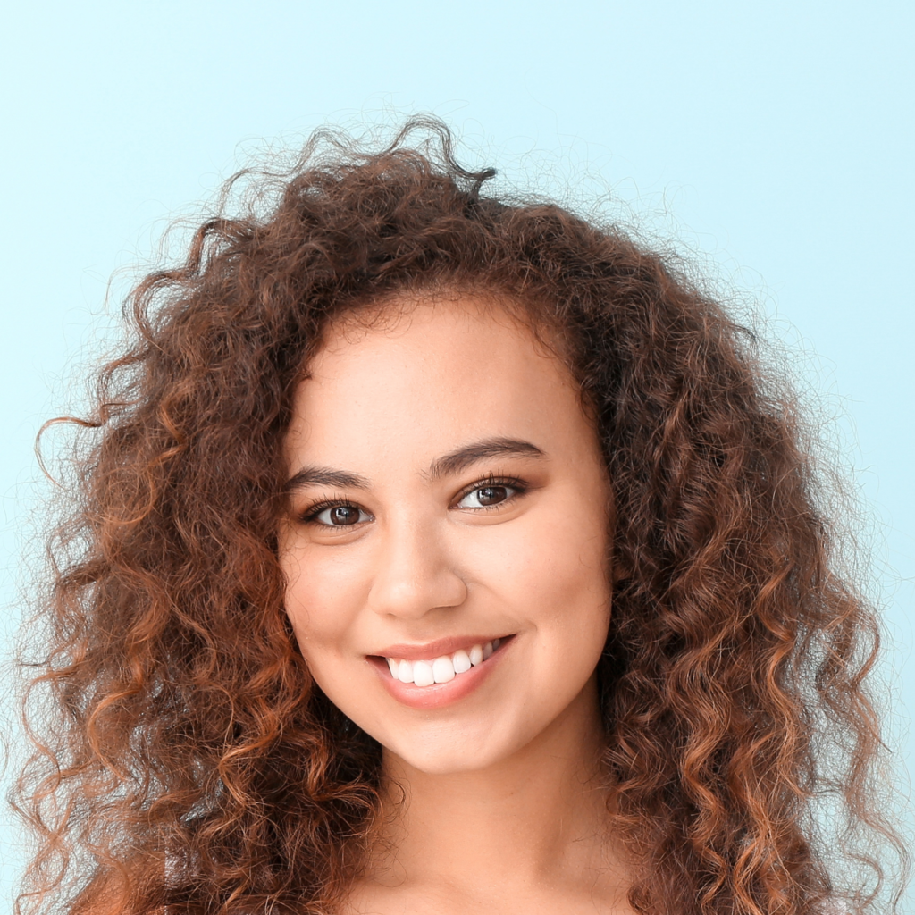 Smiling woman with fine, thin curly hair.