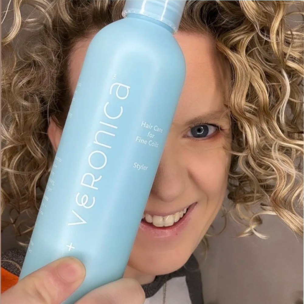 Liane Bayliss @curlycast holding van + veronica Haircare Styler