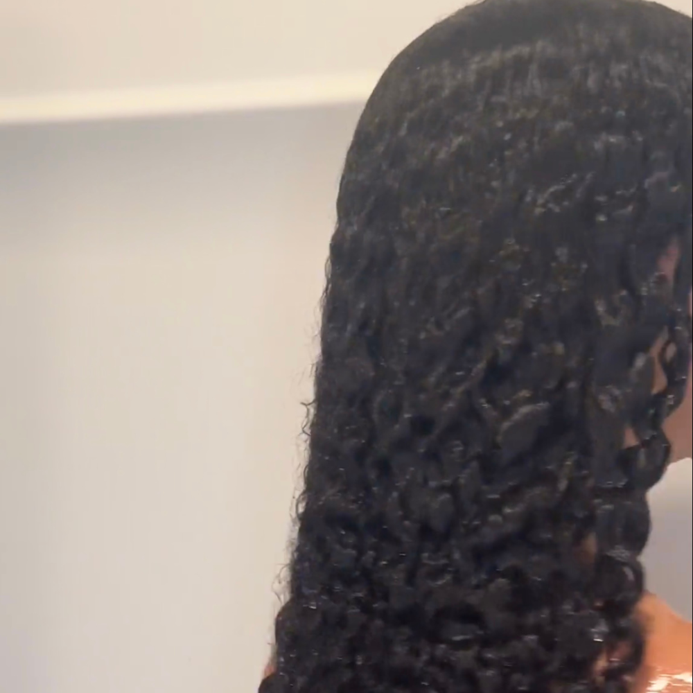 Image of woman with long curly hair in shower after using van + veronica Haircare Conditioner