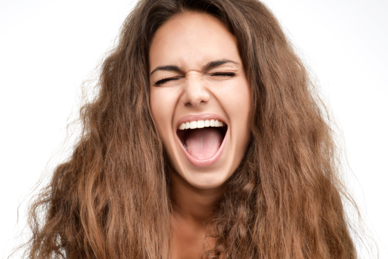 Woman with curly hair frustrated with limp curls