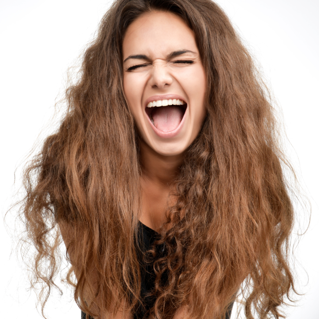 Woman with curly hair frustrated with limp curls