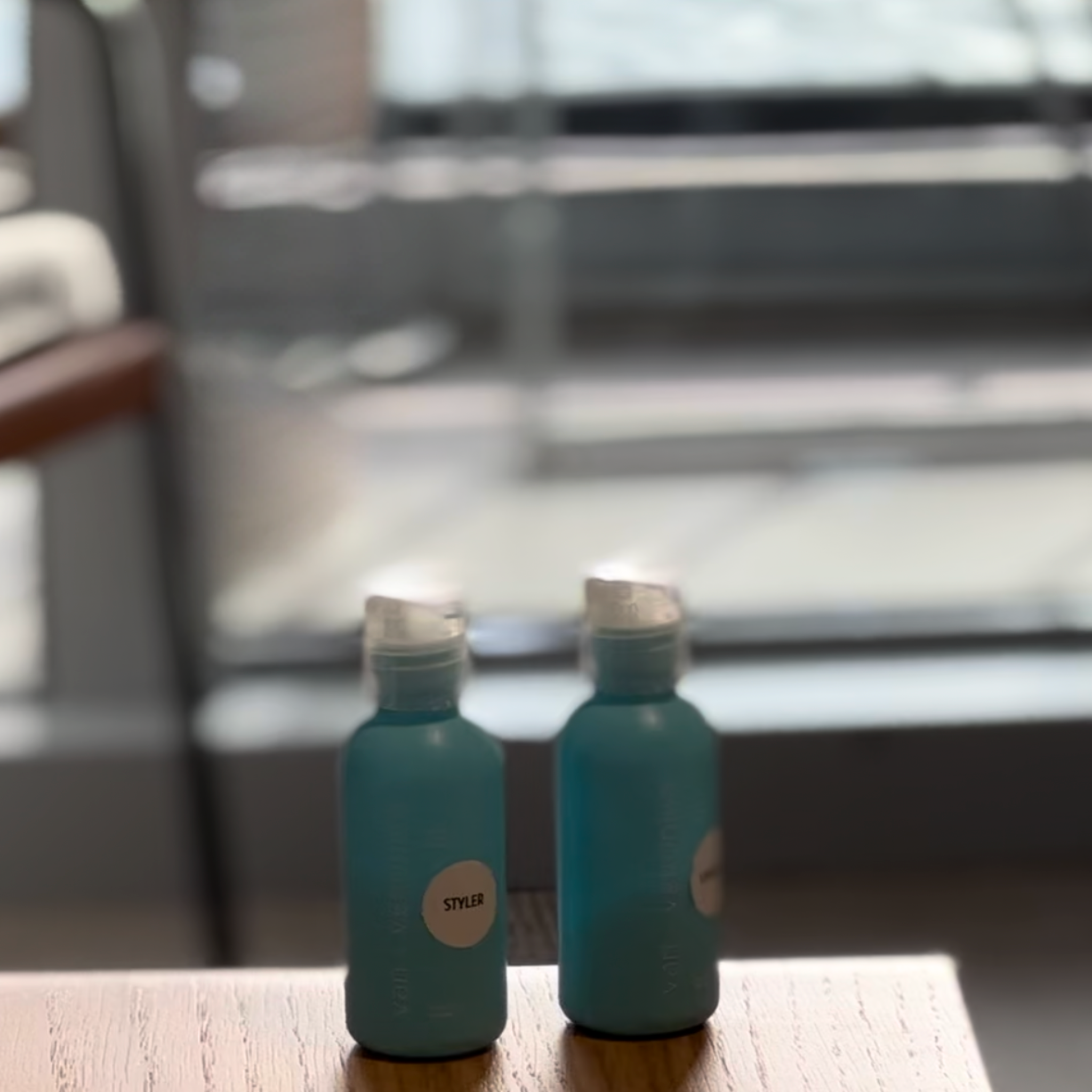 van + veronica Haircare travel minis on cruise with balcony and ocean background